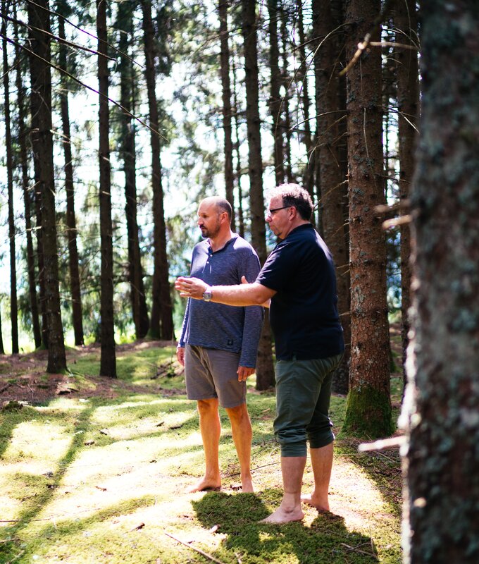 Männer stehen barfuß im Wald | © Urlaub am Bauernhof Kärnten/ Daniel Gollner