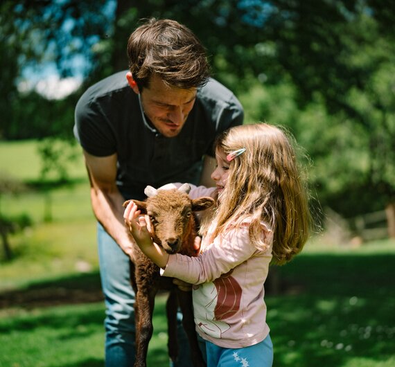 Papa mit Tochter und Babyziege | © Urlaub am Bauernhof / Daniel Gollner 