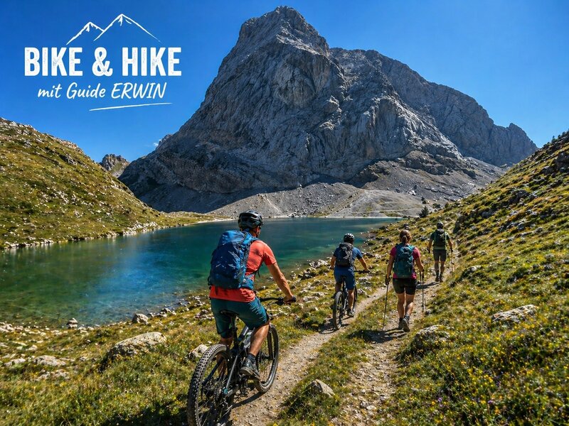 Geführte Bike & Hike Touren mit Guide Erwin am Bauernhof, mit Blick auf einen Bergsee und die umliegenden Berge.