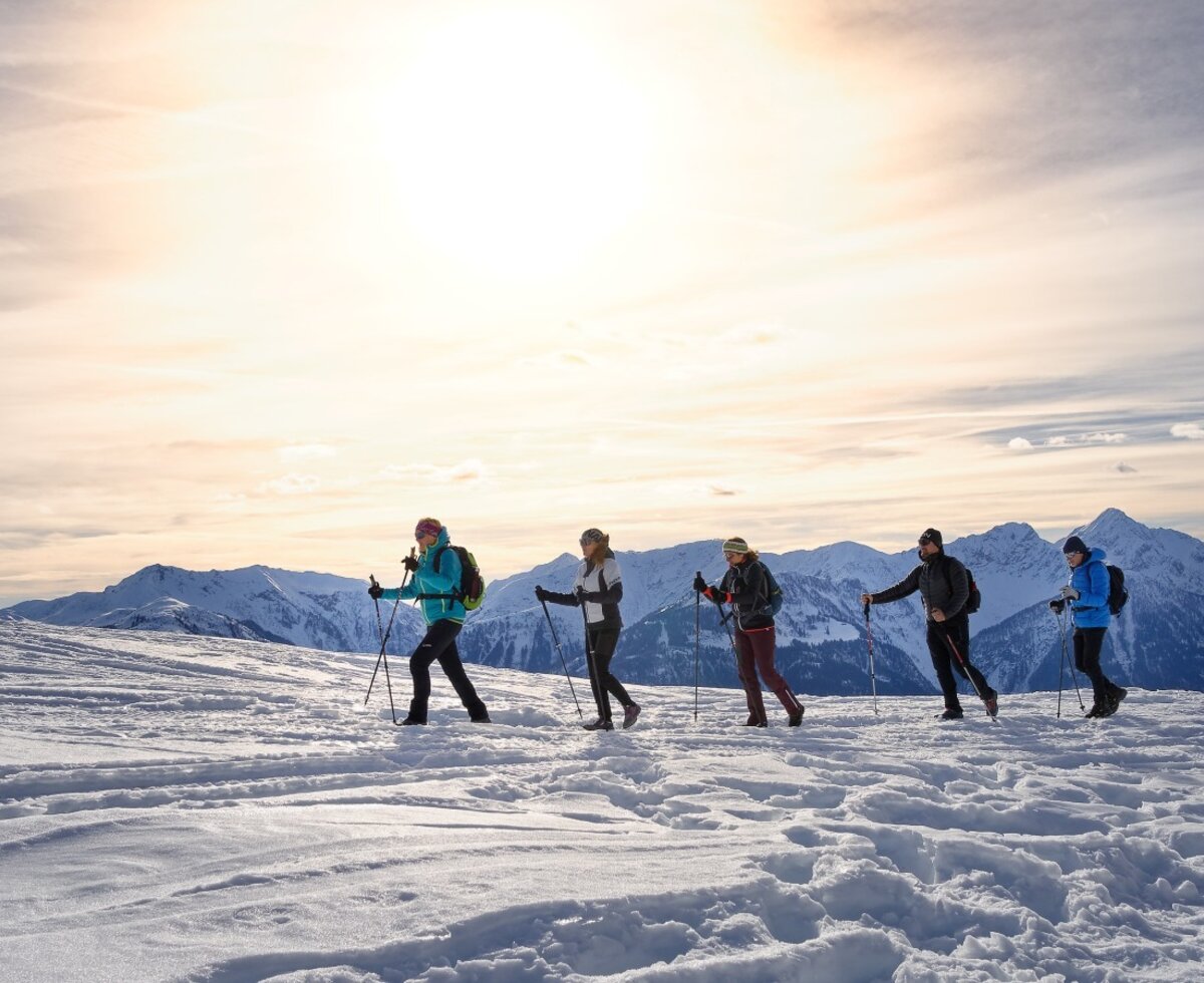 Winterwanderer in der verschneiten Berglandschaft, eine Aktivität für Gäste des Bauernhofs.