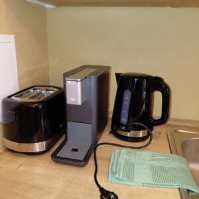 Praktisch ausgestattete Küchenecke des Winzerhofes mit einer Kaffeemaschine, einem Wasserkocher und einem Toaster.