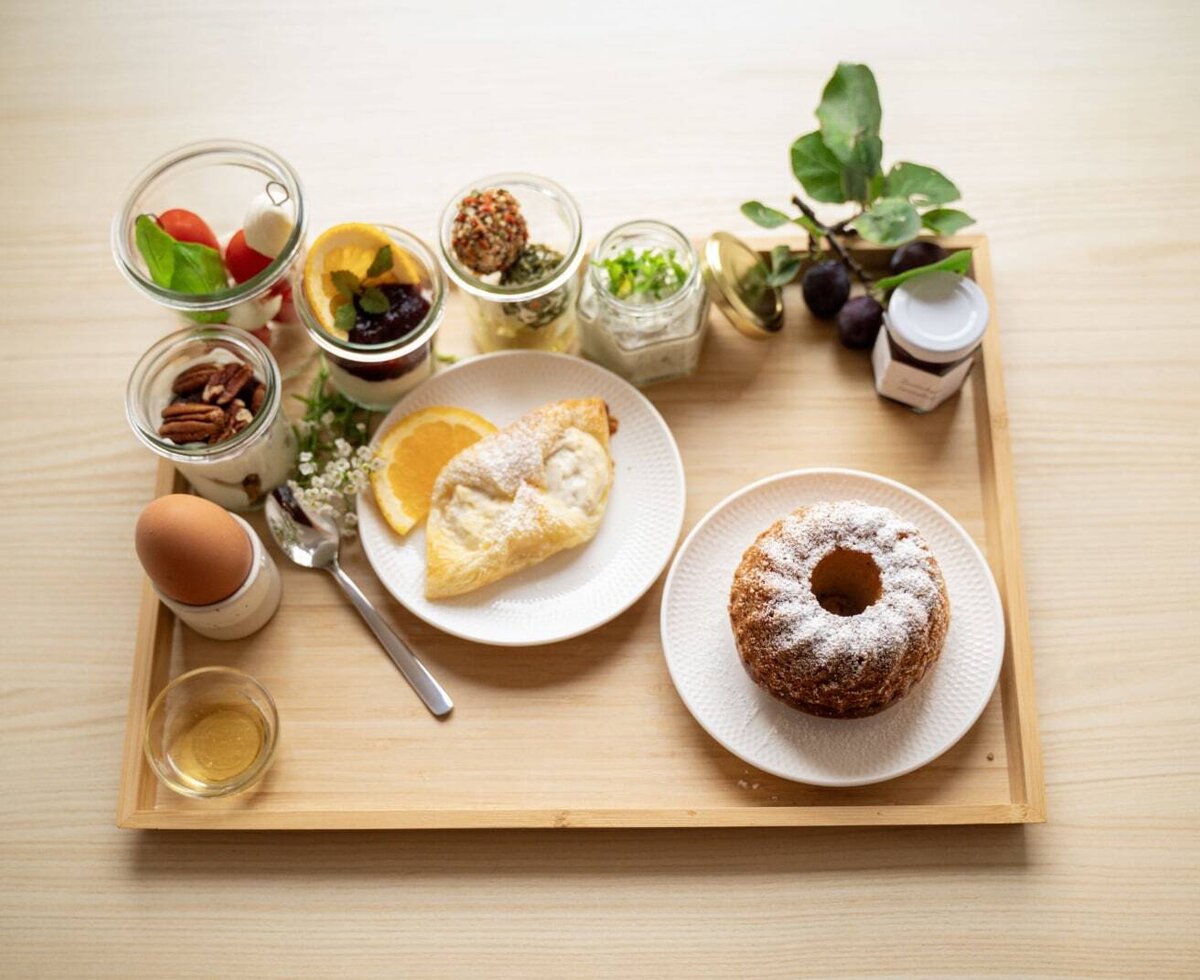 Das Frühstück auf dem Bauernhof beinhaltet Ei, Gebäck, Gugelhupf, Joghurt, Marmelade und weitere vielfältige Köstlichkeiten.