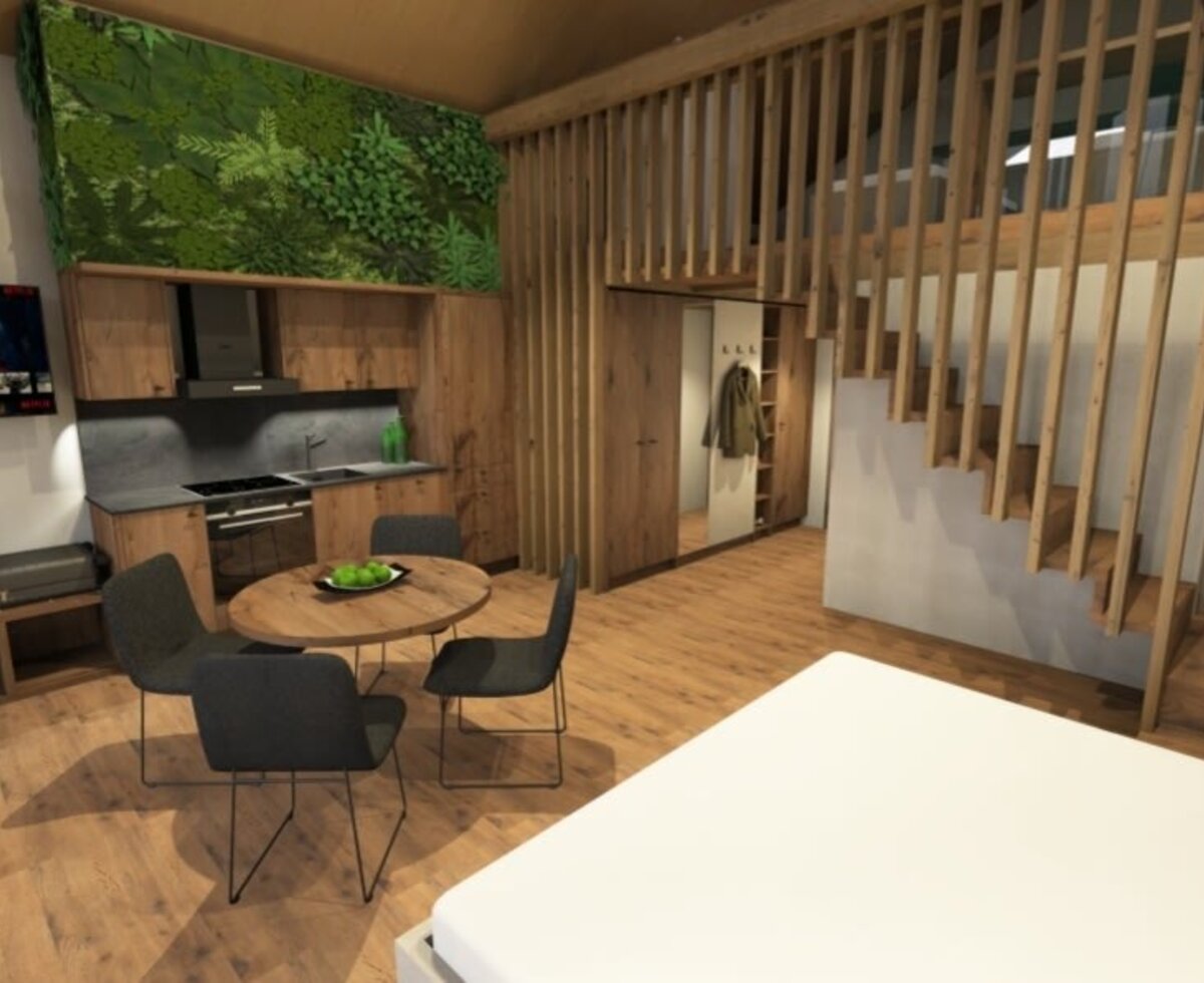 Ein einladender Wohnbereich im Bauernhof mit moderner Küchenzeile, gemütlicher Sitzecke und stilvollen Holzelementen.