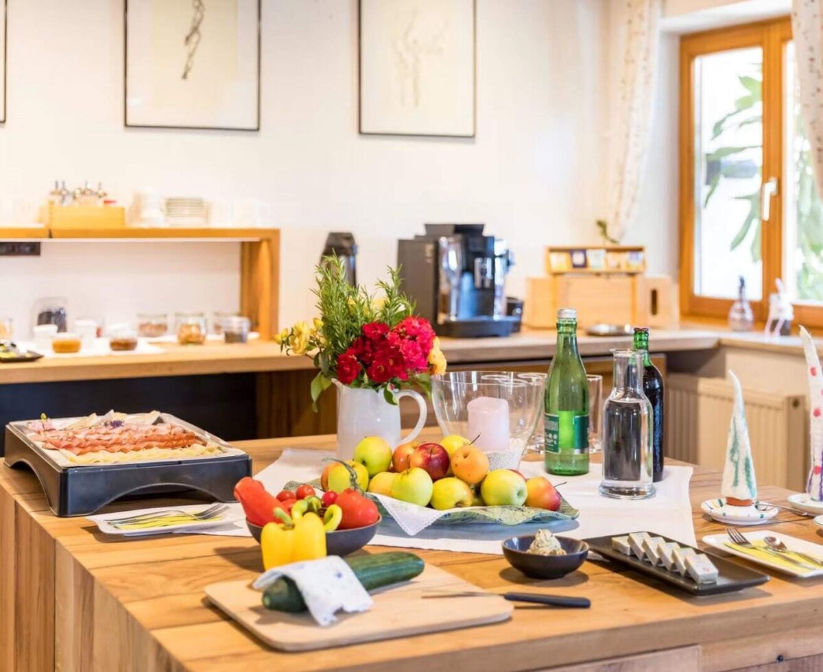 Das Frühstücksbuffet am Weingut Peter Skoff Domäne Kranachberg mit frischem Obst, Gemüse, Aufschnitt und einer Kaffeemaschine.