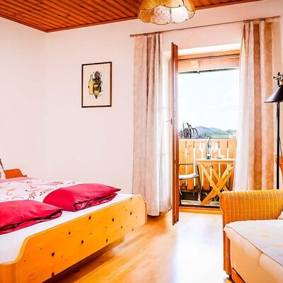 Zimmer mit Doppelbett, Sofa und Balkon mit Landschaftsblick. (c) Gregor Schiefer