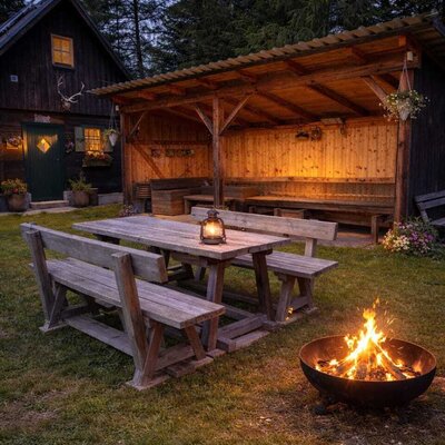 Der Außenbereich des Bed and Breakfast bietet einen Holztisch, einen überdachten Sitzbereich und eine Feuerstelle.