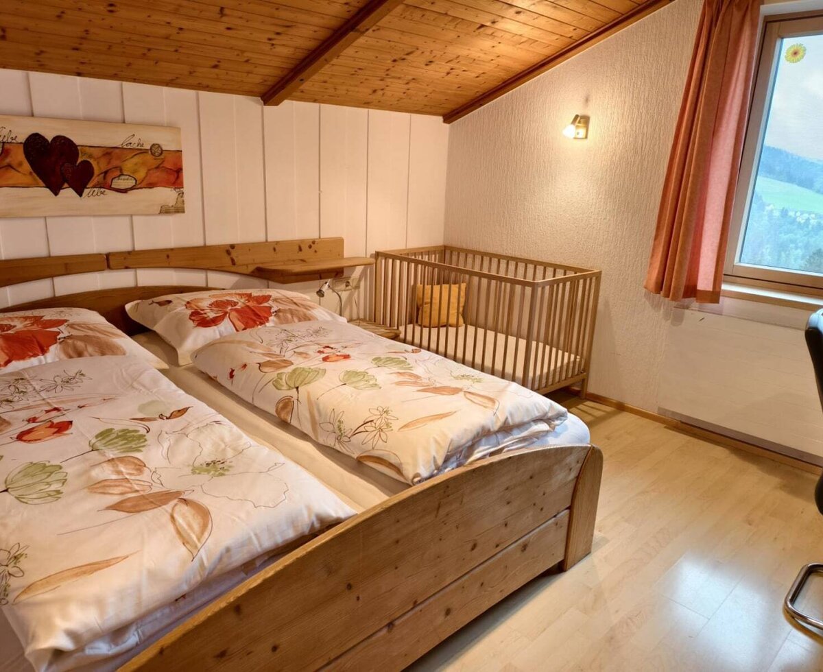 Schlafzimmer mit Doppelbett , KInderbett und Schreibtisch in der Wohnung Dreiländerblick